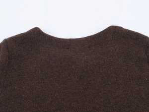 Close-up of dark brown knit collar showing high-quality wool texture and neat stitching