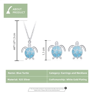 Detailed view of blue turtle necklace and stud earrings set in 925 sterling silver
