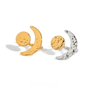 Detail of hammer-textured celestial moon and sun open rings in gold and silver finish