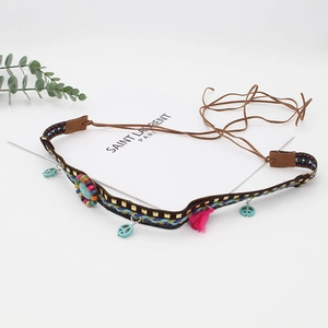 Bohemian beaded headband with turquoise peace pendant and vibrant pink fringe details