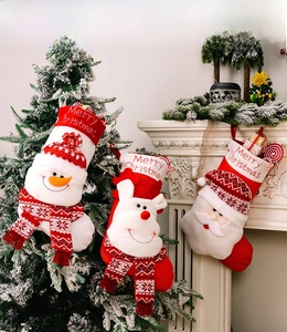 Detailed view of knitted Christmas stockings with 3D Santa, deer, and snowman embroidery