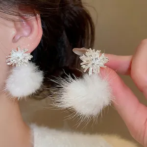 Winter snowflake stud earrings with white pompom and sparkling zircon crystal details