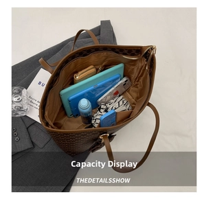 Vista superior del interior espacioso del bolso tote marrón con monograma y tableta