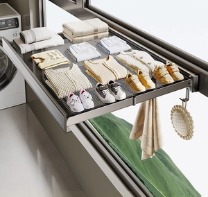 Detail of balcony retractable drying rack with mesh surface and side hooks for shoes