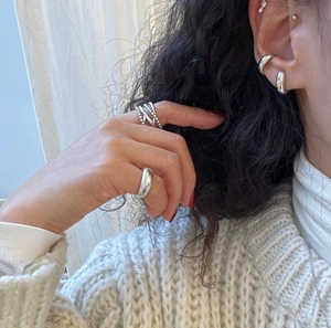 Minimalist 925 sterling silver multi-layer rings and ear cuffs worn by a model