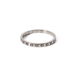 Detail of minimalist silver stainless steel ring featuring engraved floral flower patterns