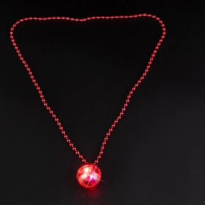 Close-up of glowing red disco ball pendant with matching bead chain on black background