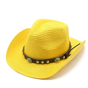Detail of yellow straw cowboy hat with leather band and turquoise stone embellishments