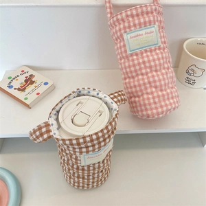 Detail showing heart-quilted checkered fabric cup sleeves with soft carry handles