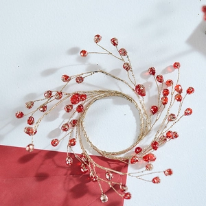 Festive red berry Christmas napkin ring with golden metallic wire and transparent beads