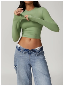 Tight-fit yoga top in light green knit fabric showing slim cut and ribbed texture