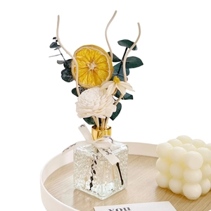 Preserved flower reed diffuser set with orange slices and eucalyptus in glass bottle