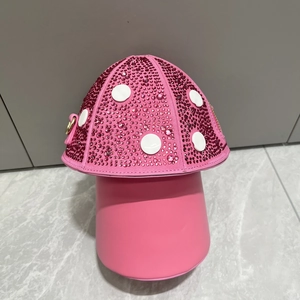 Close-up of pink mushroom handbag with sparkling rhinestones and white circular details
