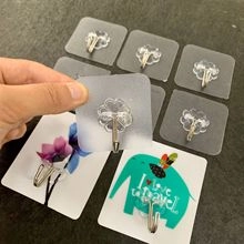 Close-up of clear adhesive hooks featuring flower-shaped PVC base and durable metal hook