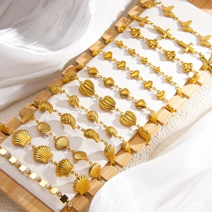 Adjustable 18k gold plated bracelets with shell wave and cross charms set on wood