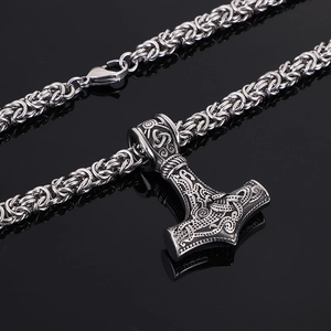 Close-up of Viking Mjolnir pendant with intricate engravings on a Byzantine chain