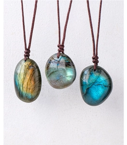 Three natural labradorite pendants with blue and gold flashes on brown braided cords