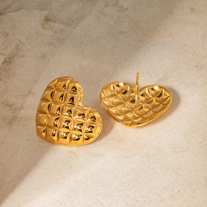 Macro shot of 18k gold stainless steel heart earrings with quilted grid pattern texture