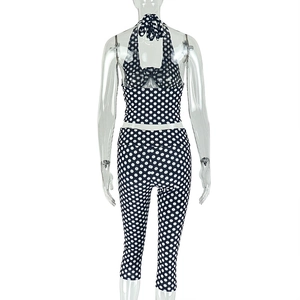 Detail view of backless halter top and polka dot leggings set on a transparent model