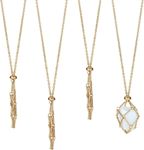 Detailed view of adjustable golden metal cage necklace holding a smooth white crystal stone