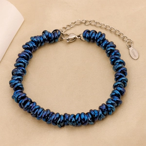 Close-up of dark blue stainless steel bracelet with silver clasp and S.steel hallmark