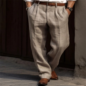 Detailed texture of men's khaki linen trousers featuring classic pleated wide leg design