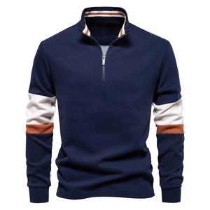 Detail of navy blue quarter-zip polo sweatshirt with orange and white sleeve stripes