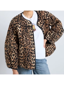 Detail of leopard print quilted jacket with black piping and button-down front closure