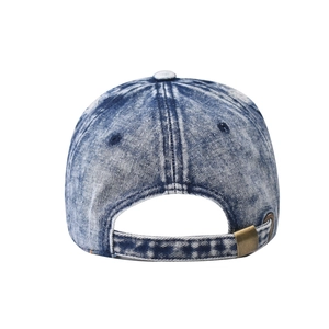 Detail of blue washed denim baseball cap with an adjustable bronze metal buckle at the back