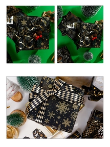 Detail of black and gold Christmas wrapping paper with snowflake patterns and matching ribbons
