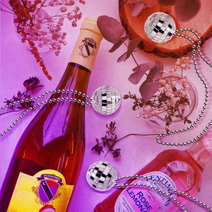 Retro disco ball necklaces with silver reflective pendants on a pink aesthetic party background