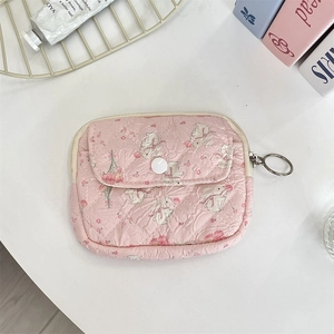 Macro shot of pink floral rabbit pattern quilted storage pouch with white snap button
