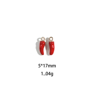 Macro view of red chili alloy pendants with gold rings, 5x17mm size and 1.04g weight