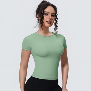 Detailed close-up of slim-fit light green yoga t-shirt with breathable performance fabric