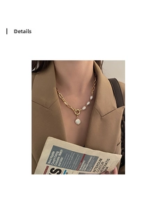 Baroque pearl pendant necklace with gold chain and OT toggle clasp on a model