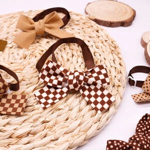 Classic autumn pet bow ties in brown checkered and polka dot styles on rustic wood decor