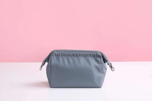 Macro view of grey waterproof nylon makeup bag with drawstring zipper detail