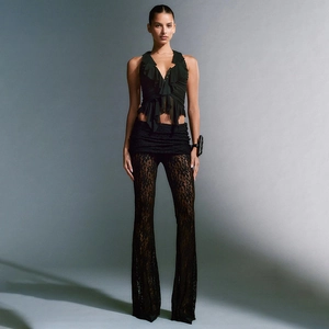 Detailed view of black lace flared pants and deep V-neck ruffled top set for women