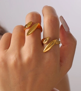 Detail view of gold-plated titanium steel rings with minimalist leaf geometric shapes