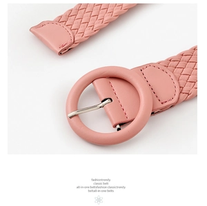 Close-up of pink woven belt featuring a round buckle and intricate braided PU leather texture