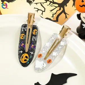 Detail of Halloween hair clips with Trick or Treat and Boo text on white ceramic plate