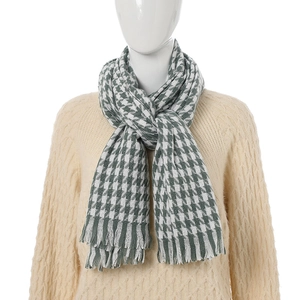 Houndstooth cashmere-like scarf in green and white with fringe on a model