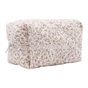 Close-up of diamond-quilted cotton fabric with pink floral pattern on storage bag