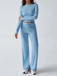 Detail of light blue Y2K two-piece set featuring long-sleeved cropped top and drawstring pants