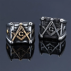 Macro shot of Freemasonry sun and moon motifs embossed on vintage stainless steel rings