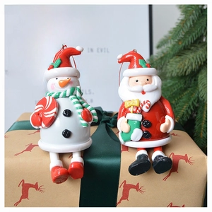 Detail of 3D Santa and Snowman polymer clay figures sitting on a gift box