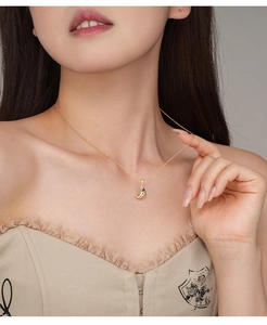 Detail of s925 silver croissant necklace with blue sapphire pendant on neck