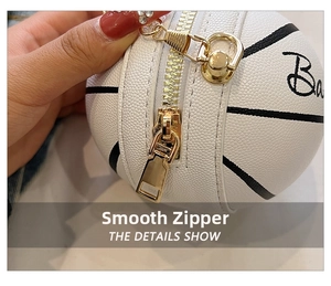 Close-up detail of smooth gold metal zipper on white leather basketball bag