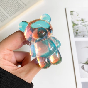 Macro detail of iridescent laser bear phone grip with glowing rainbow finish