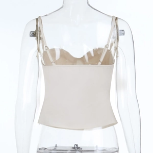 Detail view of the back of a beige slim fit cropped camisole with thin spaghetti straps